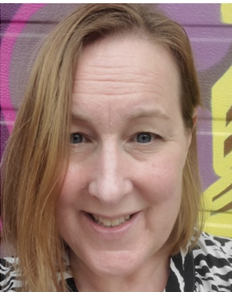 Smiling person with colorful graffiti background.