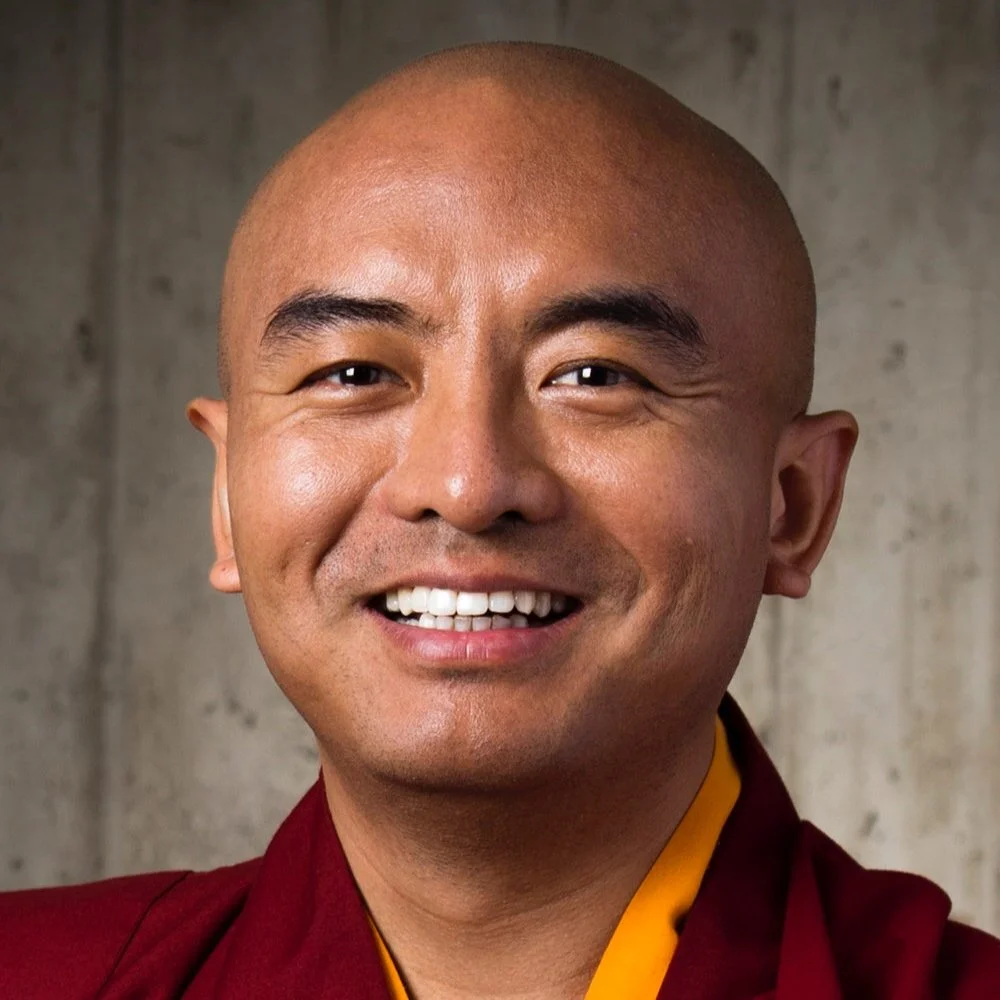 Smiling person in red robe.