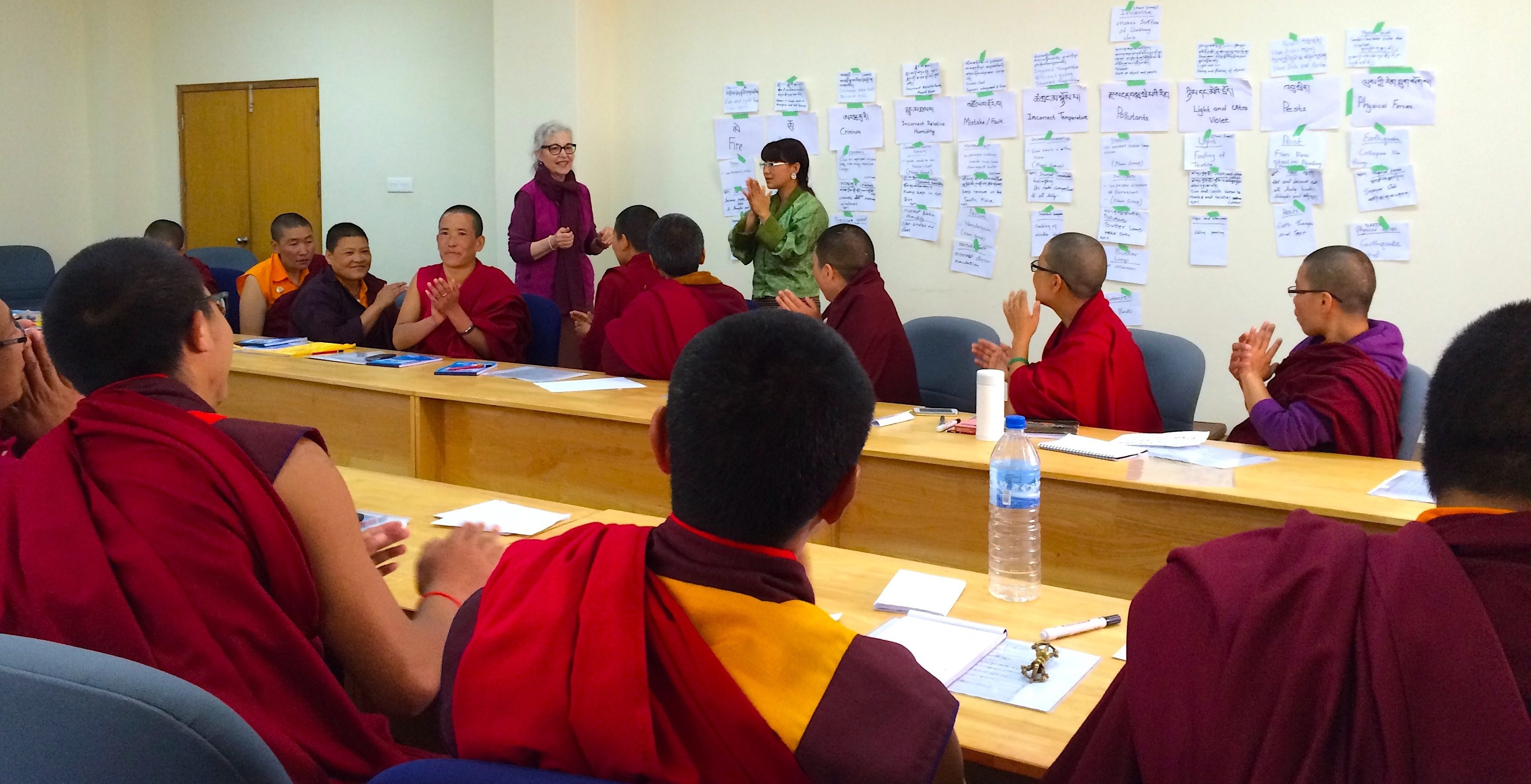 Monks gathered in a classroom for a discussion or lesson.