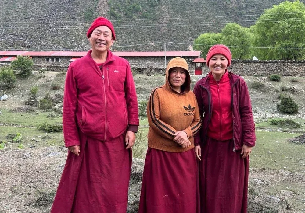 Three people in red attire outdoors.