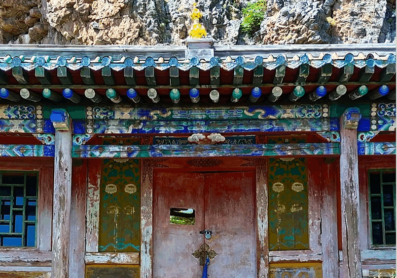 Colorful traditional building with intricate designs and a central door.